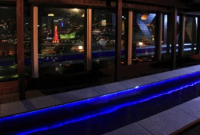 万葉倶楽部 神戸の展望足湯庭園。神戸の夜景の前に青く光る足湯が延びる