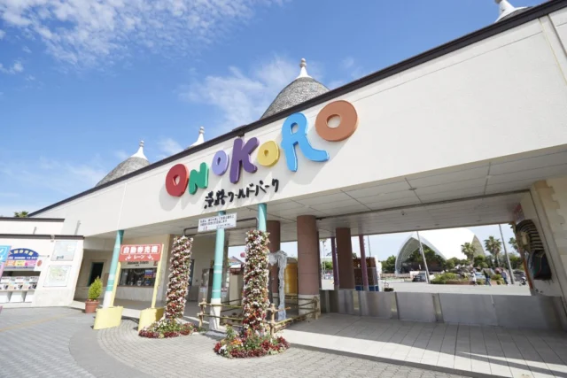 白い壁と円すい屋根、カラフルなONOKOROの文字がある入園ゲート