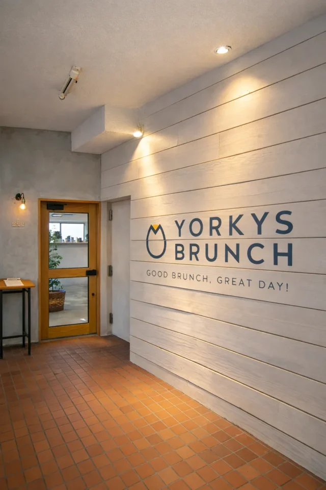 YORKYS BRUNCH公式掲載の入口。木の扉と店名入りの白い壁。撮影時期不明