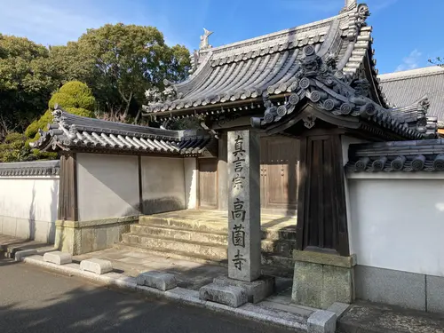 稲美町高薗寺の瓦屋根の山門と、高薗寺の名が刻まれた石柱